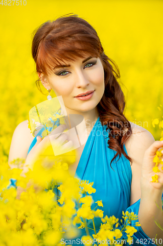 Image of beautiful girl in blue dress with yellow flowers