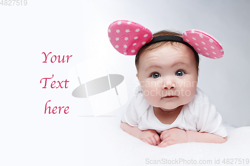 Image of funny little baby girl in mouse ears headband