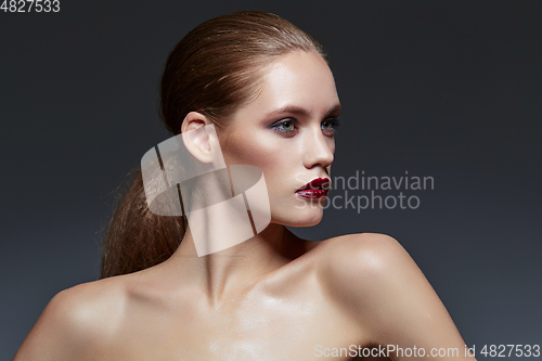 Image of beautiful girl with long ponytail and red lips