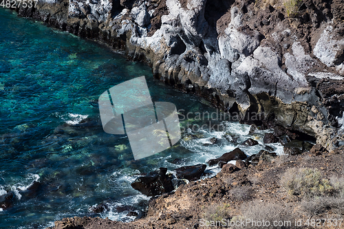 Image of beautiful view on blue ocean water and rocky coast line