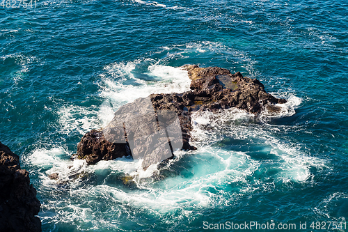 Image of beautiful view on blue ocean water and rocky coast line