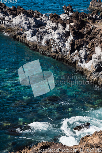 Image of beautiful view on blue ocean water and rocky coast line