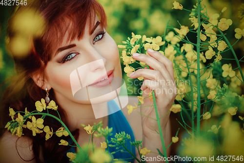 Image of beautiful girl in blue dress with yellow flowers