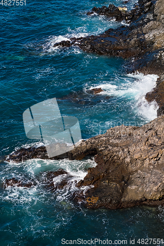 Image of beautiful view on blue ocean water and rocky coast line