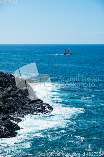 Image of beautiful view on ocean water and black lava sand