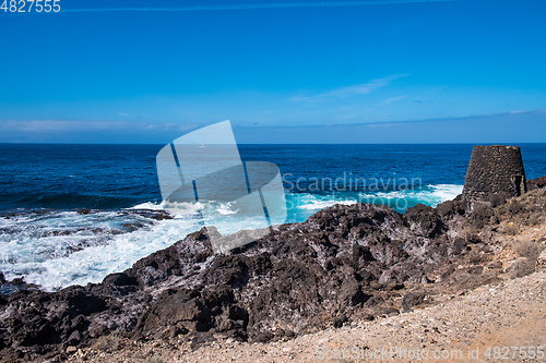 Image of beautiful view on ocean water and black lava sand