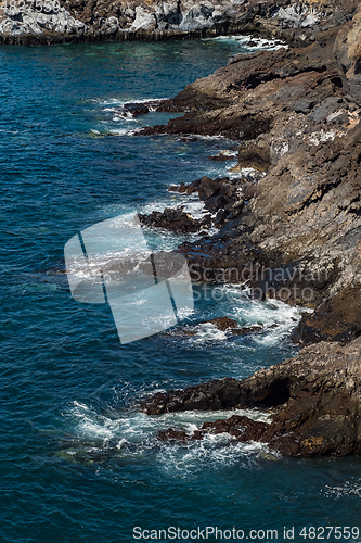 Image of beautiful view on ocean water and black lava sand