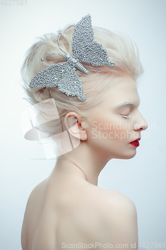 Image of beautiful albino girl with red lips on white background