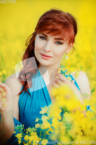 Image of beautiful girl in blue dress with yellow flowers