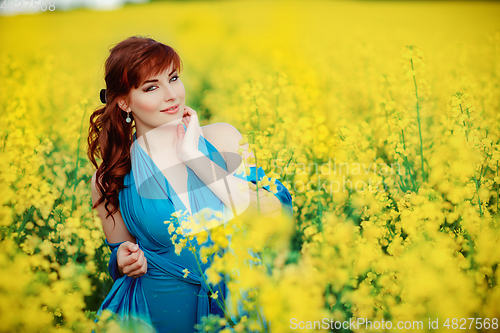 Image of beautiful girl in blue dress with yellow flowers