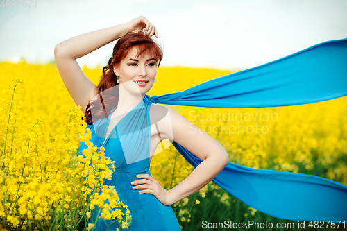 Image of beautiful girl in blue dress with yellow flowers