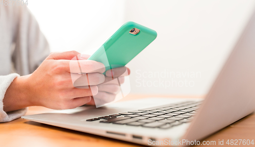 Image of Using cellphone and laptop computer