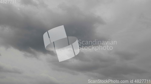 Image of Time lapse Nature background Ominous clouds drift slowly across the sky, threatening rain. UltraHD stock footage