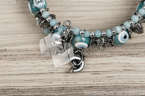 Image of woman bracelet on wooden background