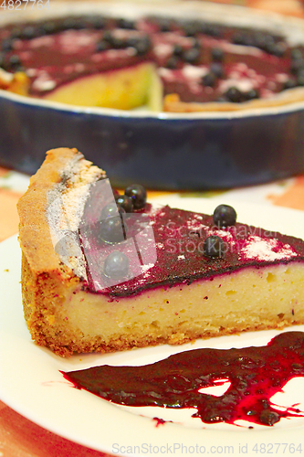 Image of Piece of pie with bilberry on the plate