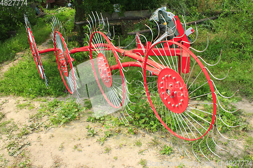 Image of agricultural tractor equipment to collect the hay