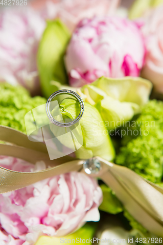 Image of wedding ring and beautiful flowers.
