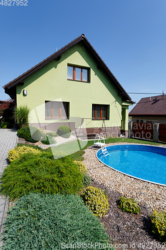 Image of beautiful green colored rural house