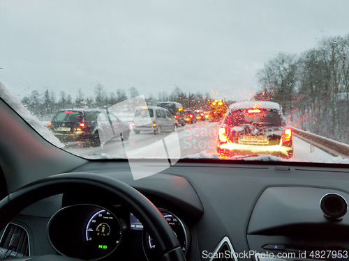 Image of snowstorm, poor car driving on slick roads