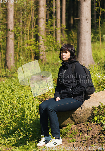 Image of woman, on hiking trip resting
