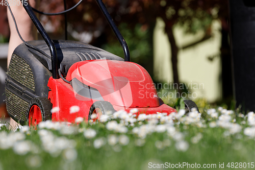 Image of lawnmower on green grass