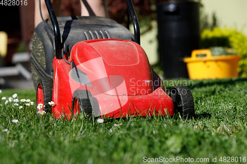 Image of lawnmower on green grass