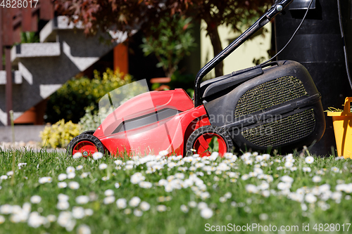 Image of lawnmower on green grass