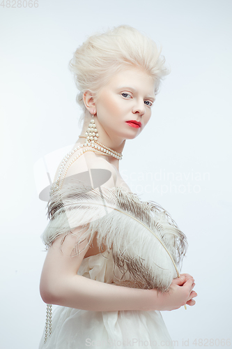 Image of beautiful albino girl with red lips on white background