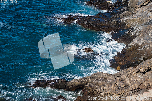 Image of beautiful view on blue ocean water and rocky coast line