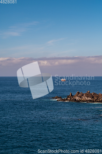 Image of beautiful view on blue ocean water and rocky coast line