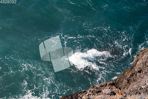 Image of beautiful view on ocean water and black lava sand