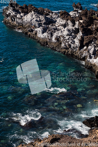 Image of beautiful view on blue ocean water and rocky coast line