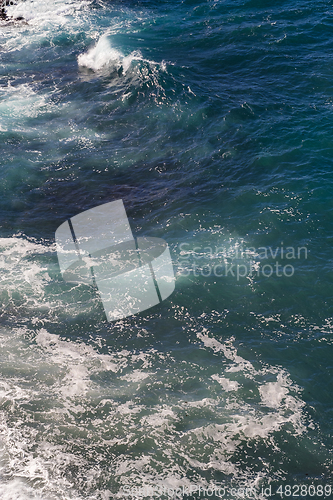 Image of beautiful view on ocean water and black lava sand