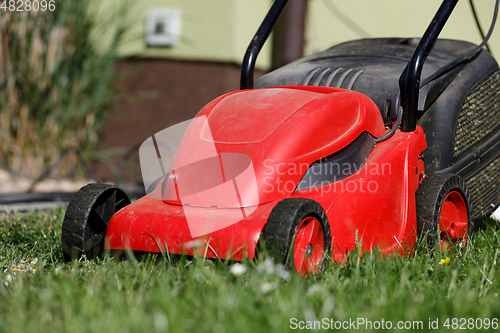 Image of lawnmower on green grass