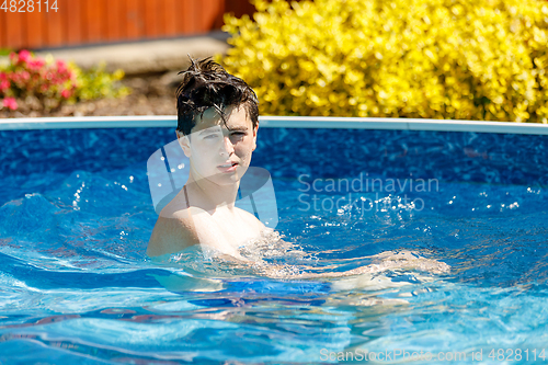 Image of Boy swimming in pool