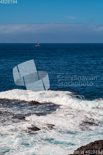 Image of beautiful view on ocean water and black lava sand