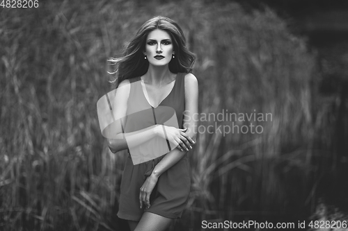 Image of black and white portrait of beautiful girl in field