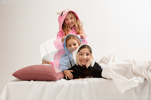 Image of Children in soft warm pajamas having party colored bright playing at home