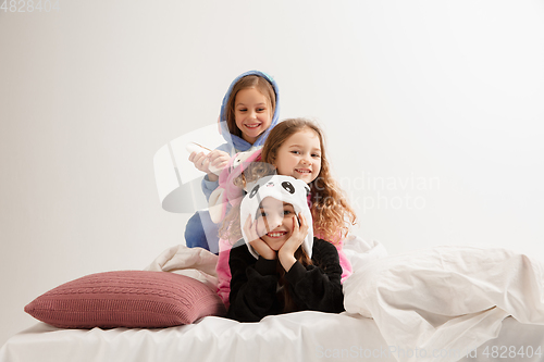 Image of Children in soft warm pajamas having party colored bright playing at home