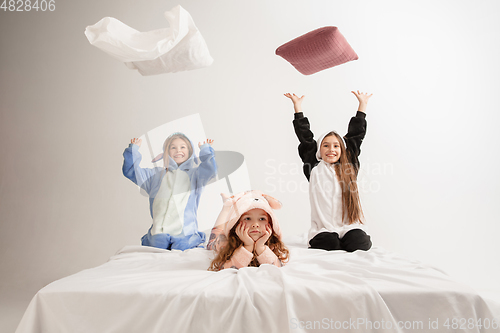 Image of Children in soft warm pajamas having party colored bright playing at home