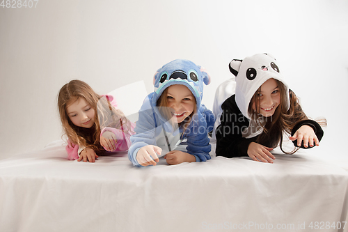 Image of Children in soft warm pajamas having party colored bright playing at home