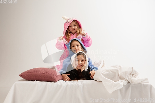 Image of Children in soft warm pajamas having party colored bright playing at home