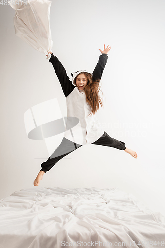 Image of Little girl in soft warm pajama having party colored bright playing at home