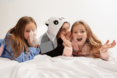 Image of Children in soft warm pajamas having party colored bright playing at home