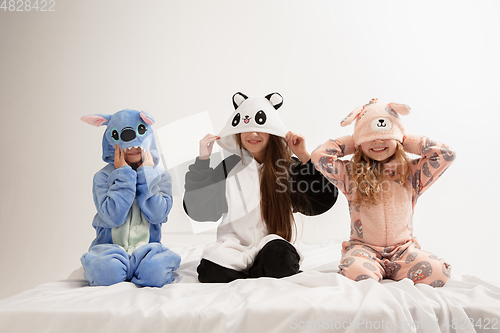 Image of Children in soft warm pajamas having party colored bright playing at home