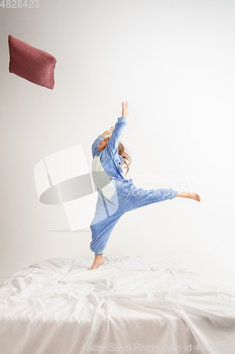 Image of Little girl in soft warm pajama having party colored bright playing at home