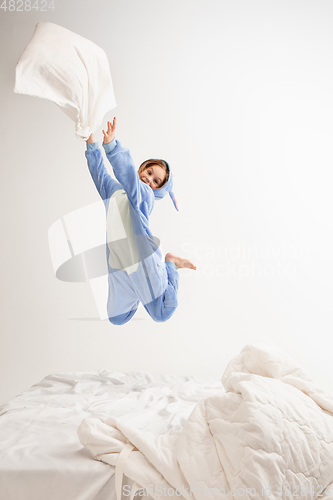 Image of Little girl in soft warm pajama having party colored bright playing at home