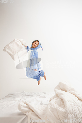 Image of Little girl in soft warm pajama having party colored bright playing at home