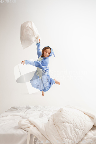 Image of Little girl in soft warm pajama having party colored bright playing at home