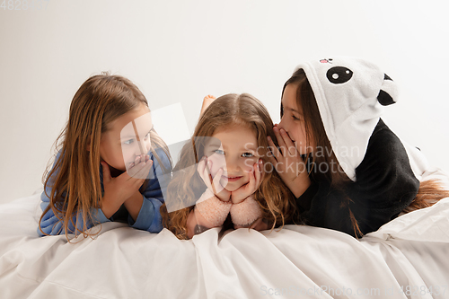 Image of Children in soft warm pajamas having party colored bright playing at home